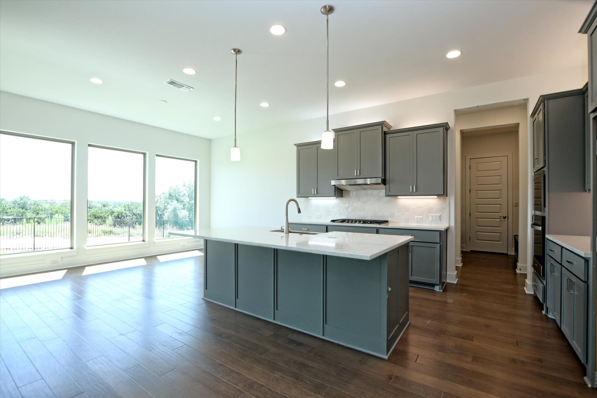 1209 Stormy Drive Georgetown, TX 78628 - Photo 13 of 38 a kitchen with stainless steel appliances granite countertop a sink a stove and a refrigerator