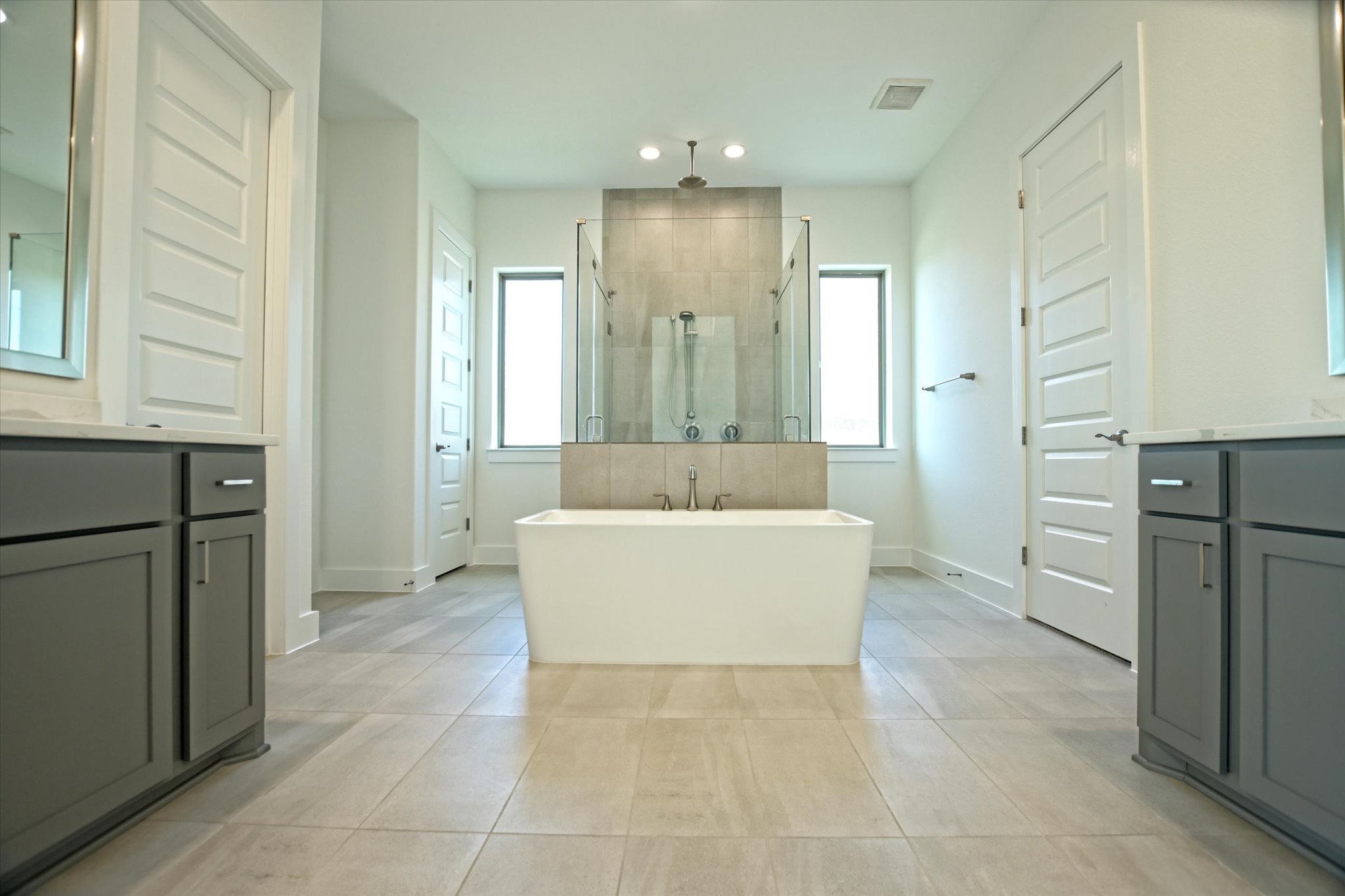 1209 Stormy Drive Georgetown, TX 78628 - Photo 22 of 38 a white bath tub sitting in a kitchen with white cabinets