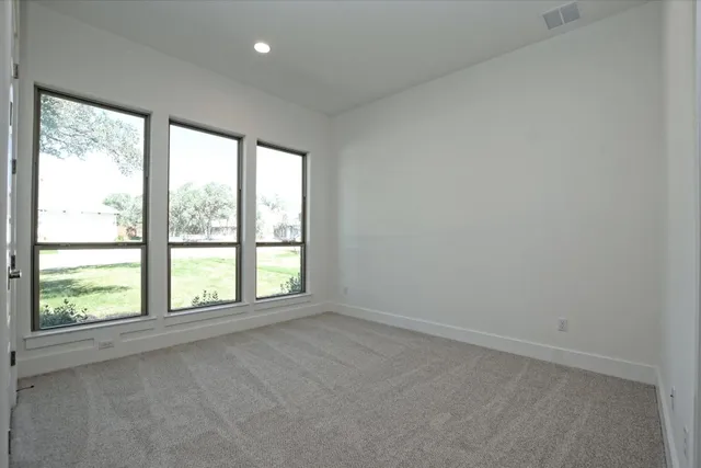 a bathroom with a granite countertop bathtub shower sink vanity and toilet