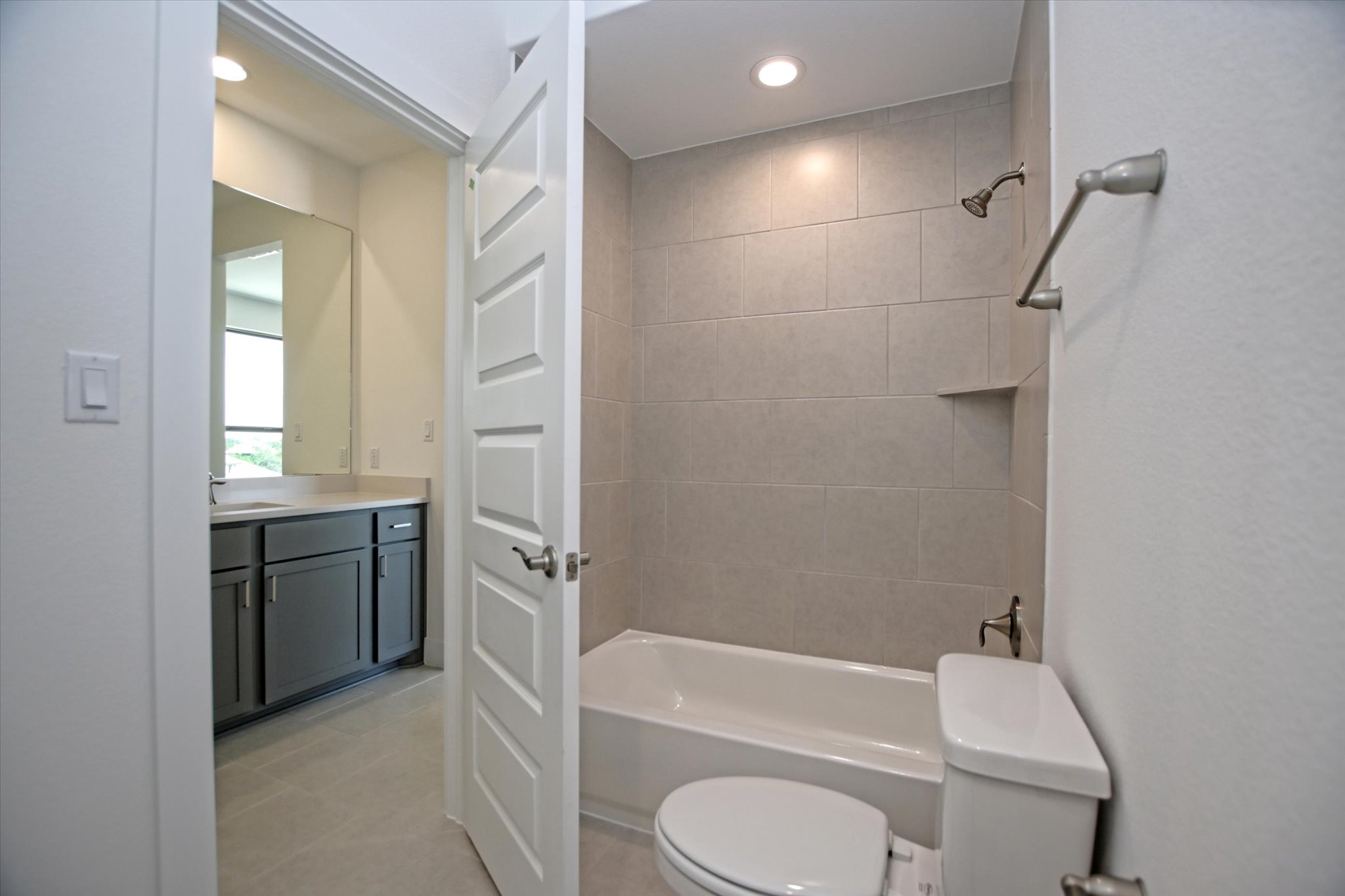 1209 Stormy Drive Georgetown, TX 78628 - Photo 32 of 38 a bathroom with a granite countertop bathtub shower sink vanity and toilet