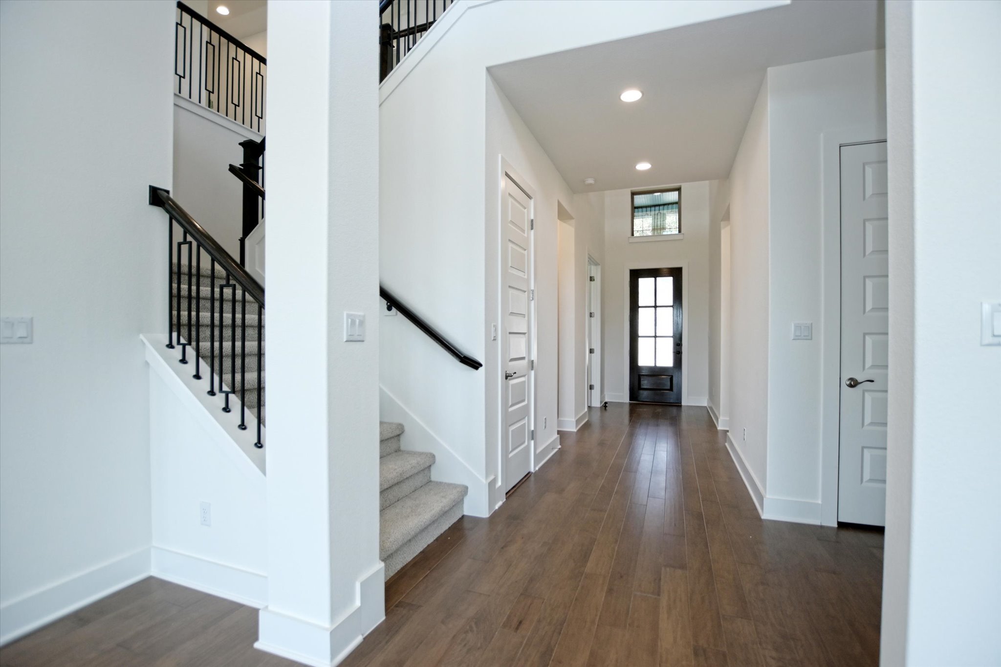 1209 Stormy Drive Georgetown, TX 78628 - Photo 4 of 38 a view of a hallway with wooden floor and stairs