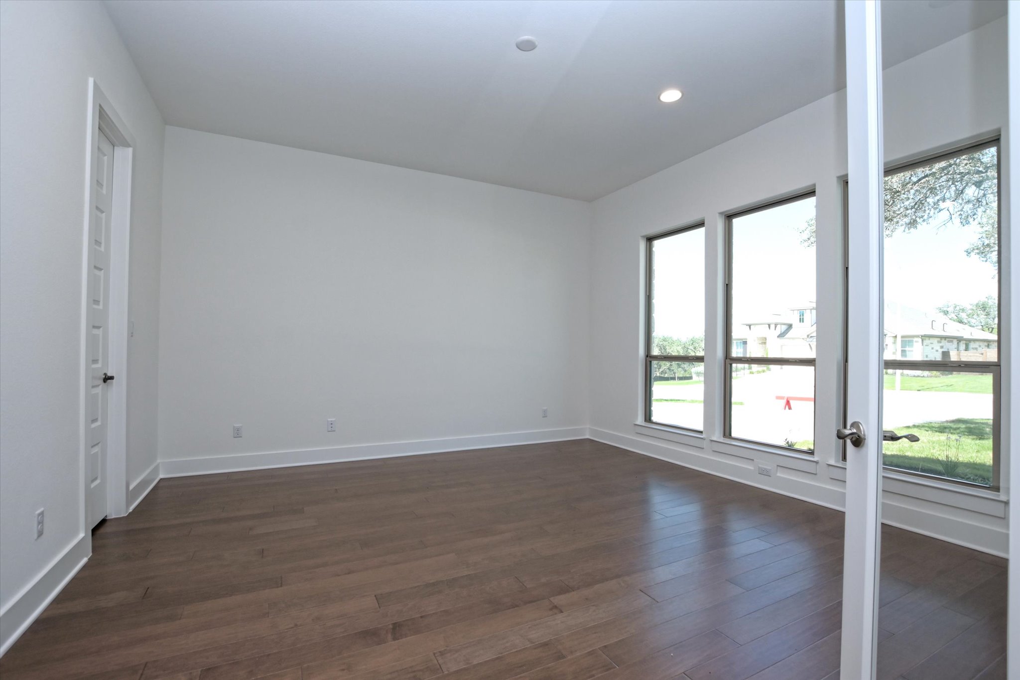 1209 Stormy Drive Georgetown, TX 78628 - Photo 6 of 38 wooden floor in an empty room with a window