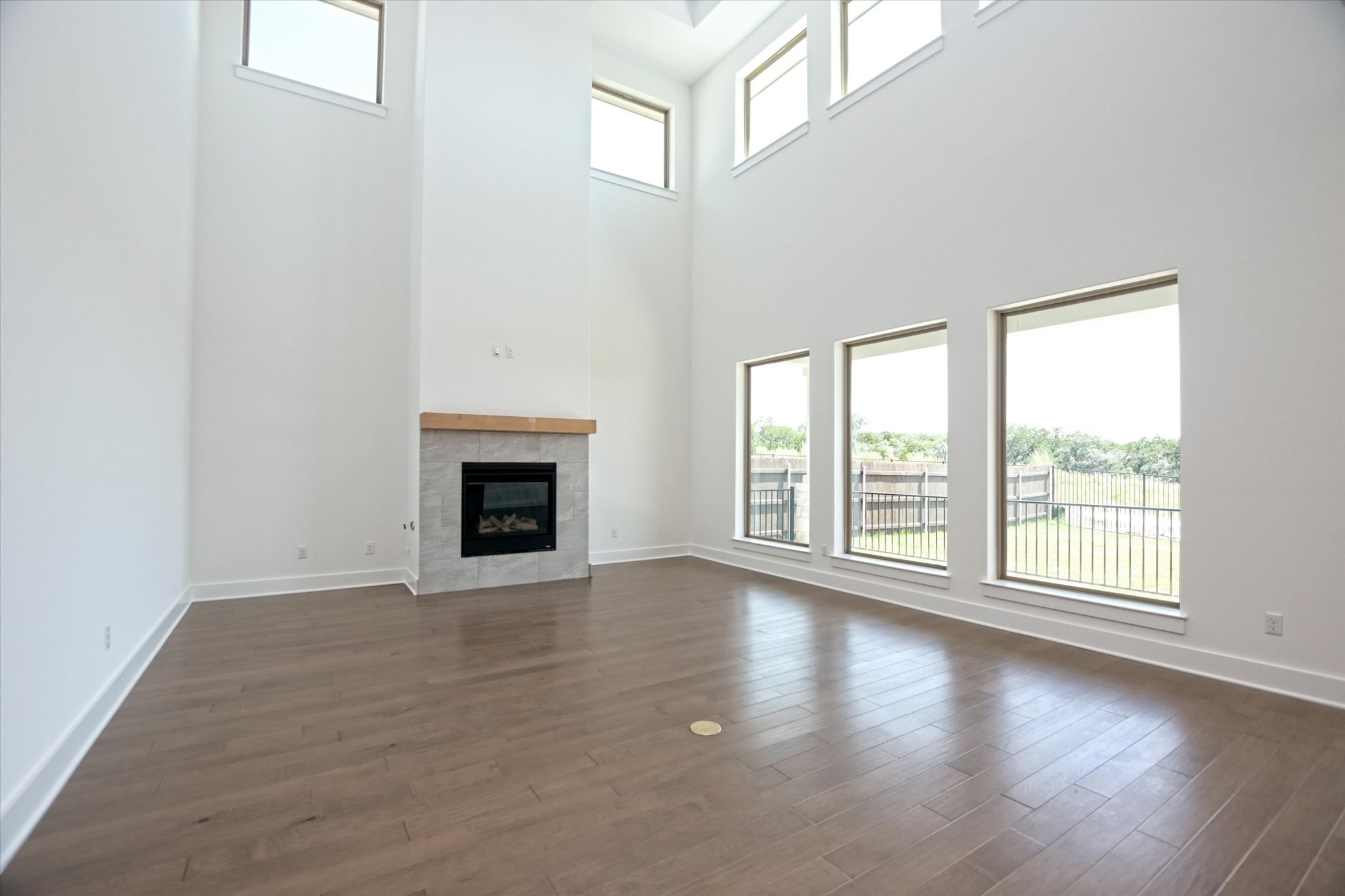 1209 Stormy Drive Georgetown, TX 78628 - Photo 7 of 38 a view of an empty room with wooden floor and a window