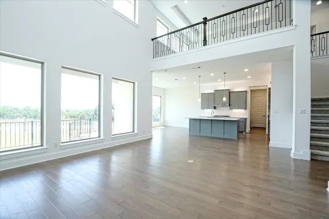 a kitchen with sink a stove and wooden floor