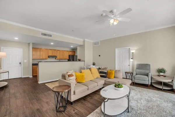 a living room with furniture and kitchen view