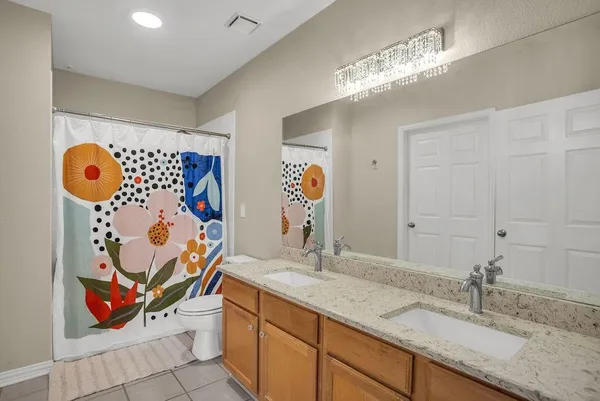 a bathroom with a double vanity sink and a mirror