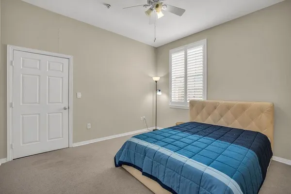 a bedroom with a large bed and a chandelier