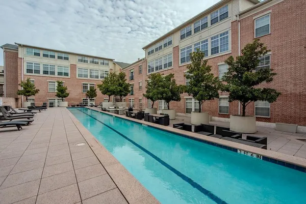 a swimming pool view with a outdoor seating