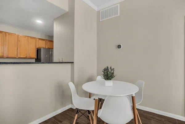 a view of a kitchen area with furniture and wooden floor