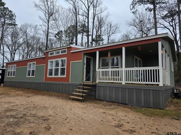 a view of a house with a yard covered in snow