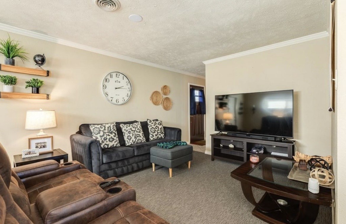 820 Perry Street Angleton, TX 77515 - Photo 9 of 26 a living room with furniture and a flat screen tv