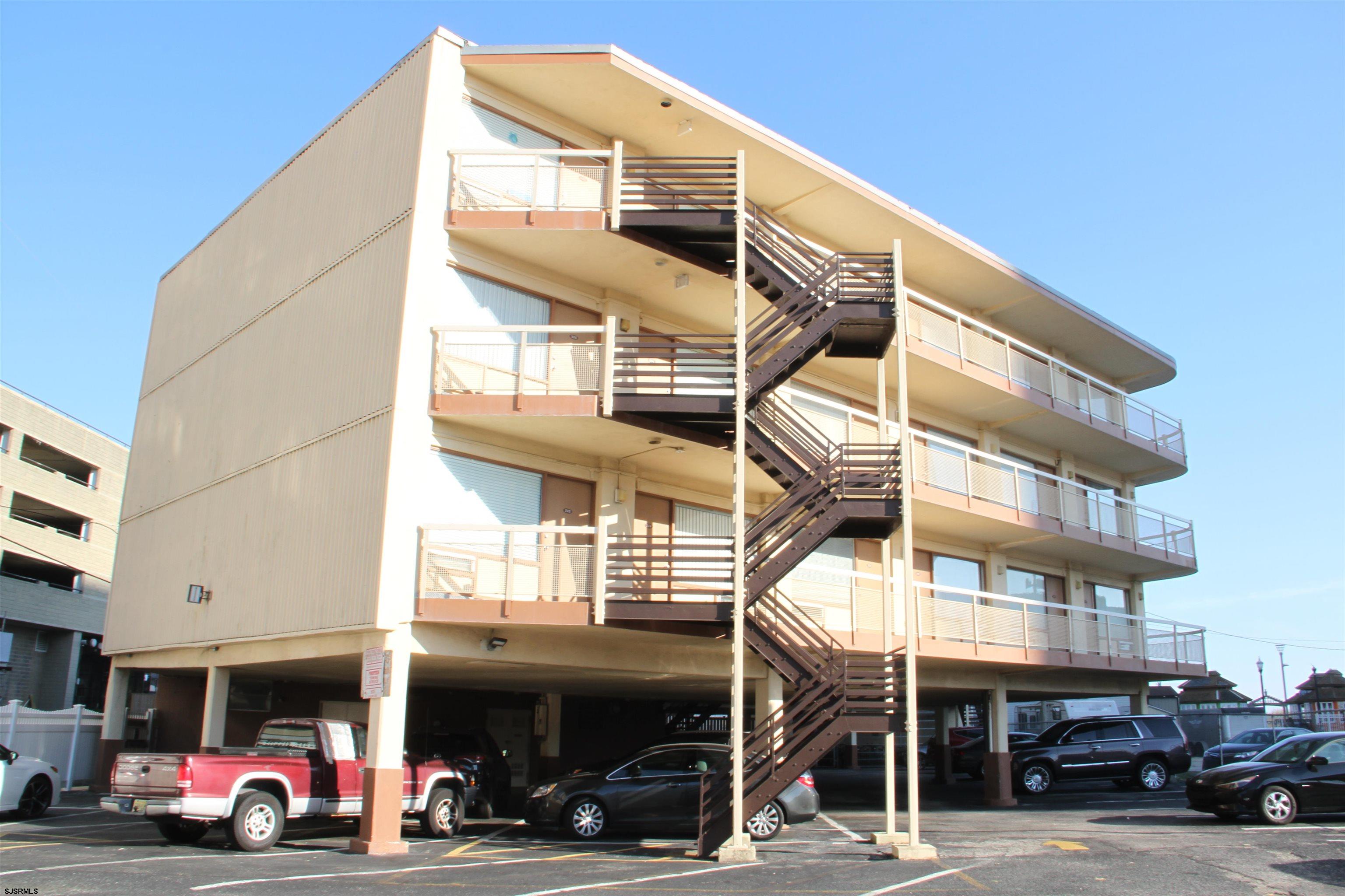 a front view of a building with parking
