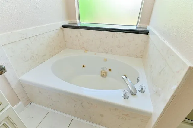 a white bath tub sitting next to a window