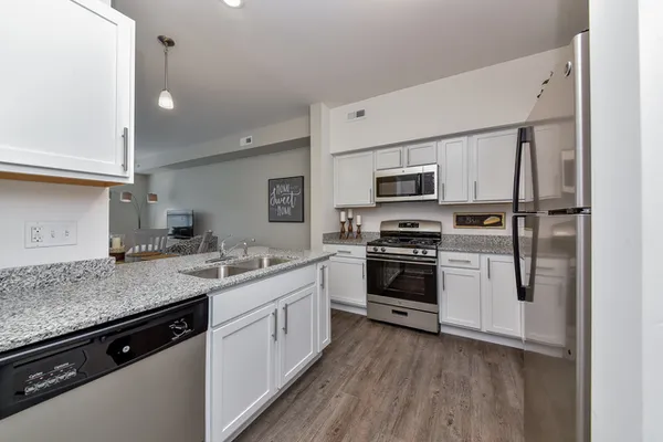 a kitchen with a sink stove and microwave