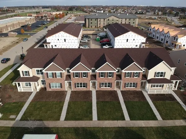 an aerial view of a house with a yard