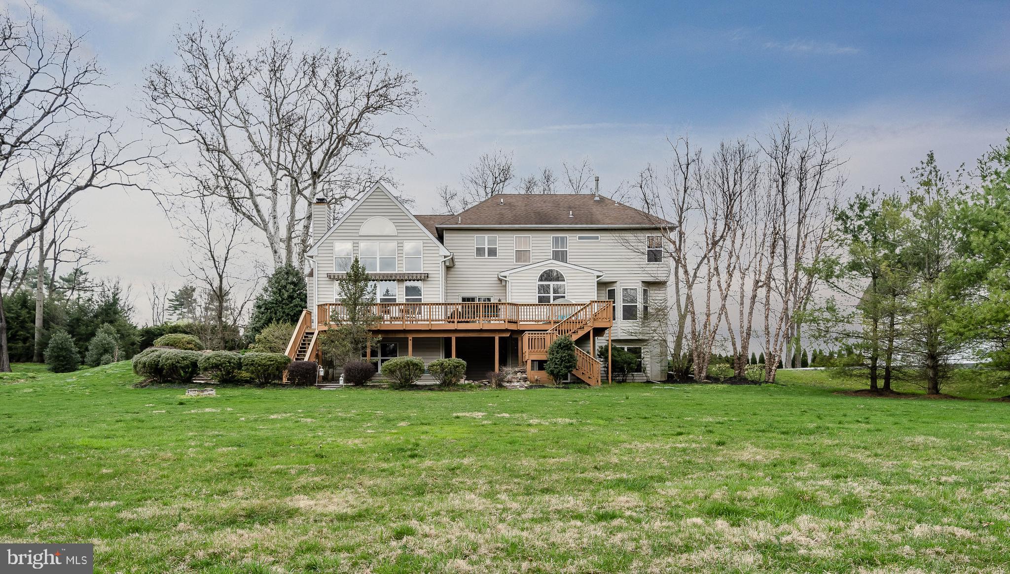 Expansive deck, patios, koi pond, walls of windows