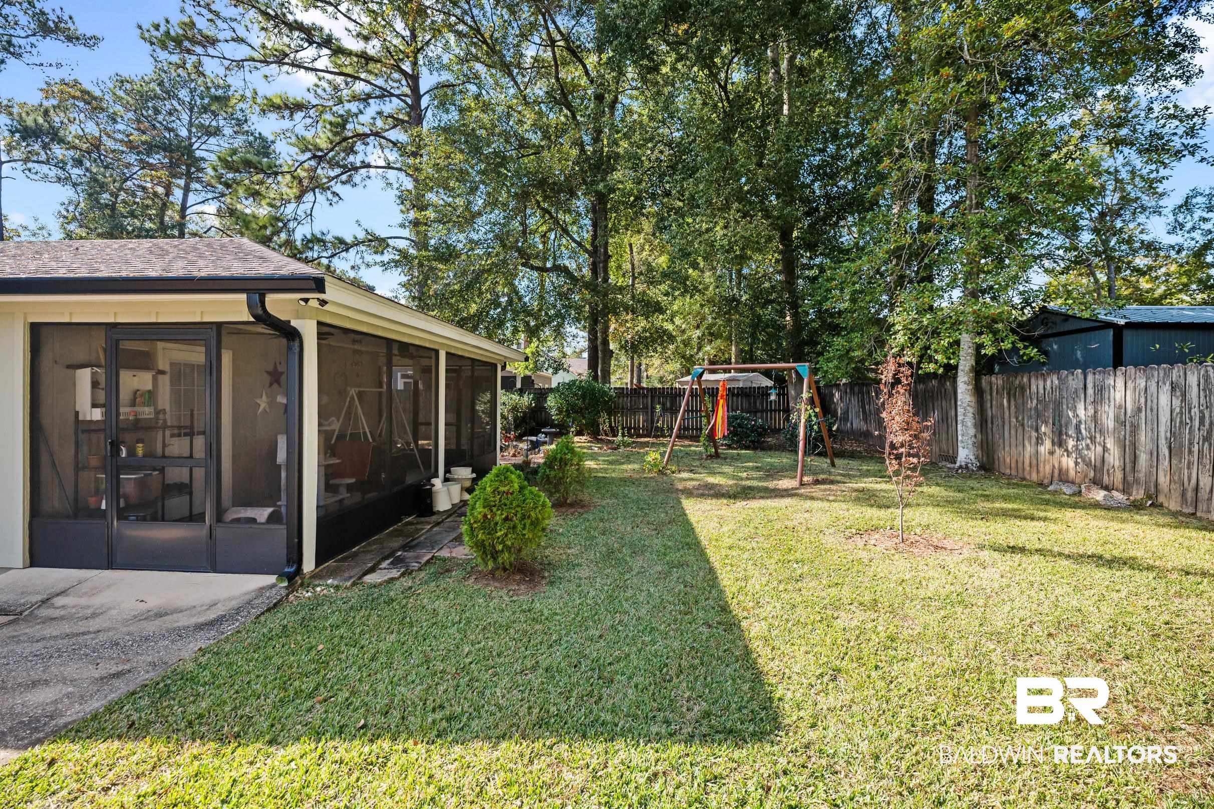 123 Dunbar Loop Daphne, AL 36526 - Photo 32 of 33 Fenced backyard featuring a playground and a sunroom