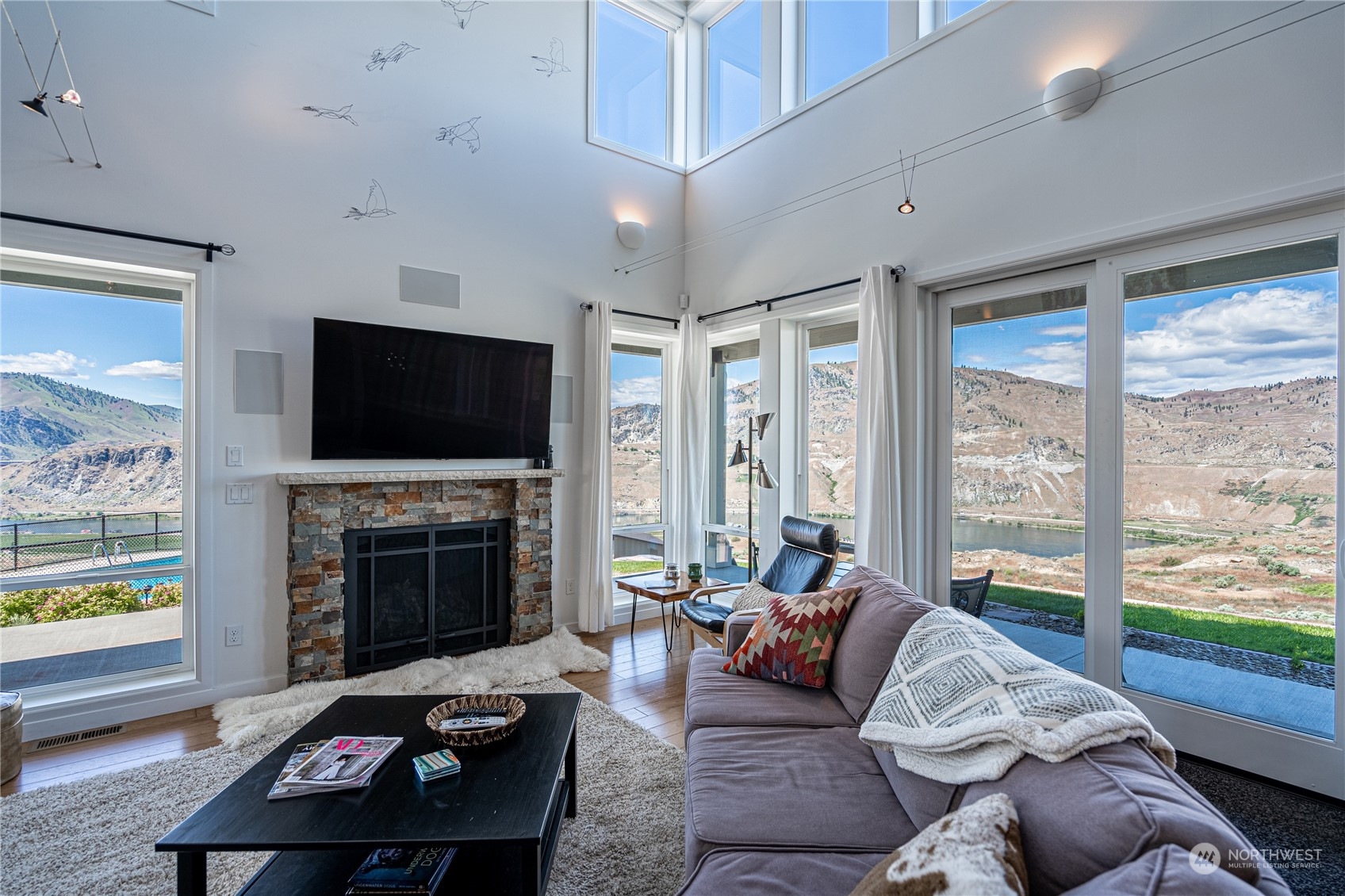 200 Ridge Road Orondo, WA 98843 - Photo 11 of 40 a living room with furniture a flat screen tv and a fireplace