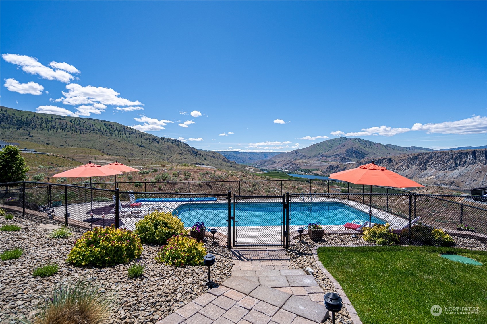 200 Ridge Road Orondo, WA 98843 - Photo 31 of 40 a view of a patio with a table and chairs under an umbrella