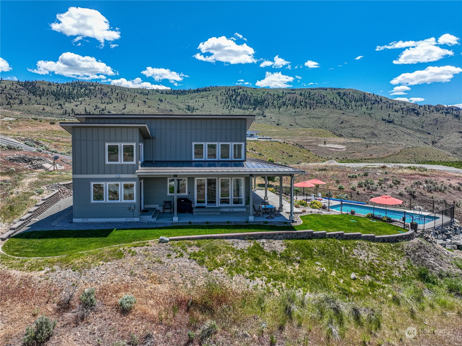 200 Ridge Road Orondo, WA 98843 - Photo 32 of 40 a view of a house with a yard balcony and swimming pool