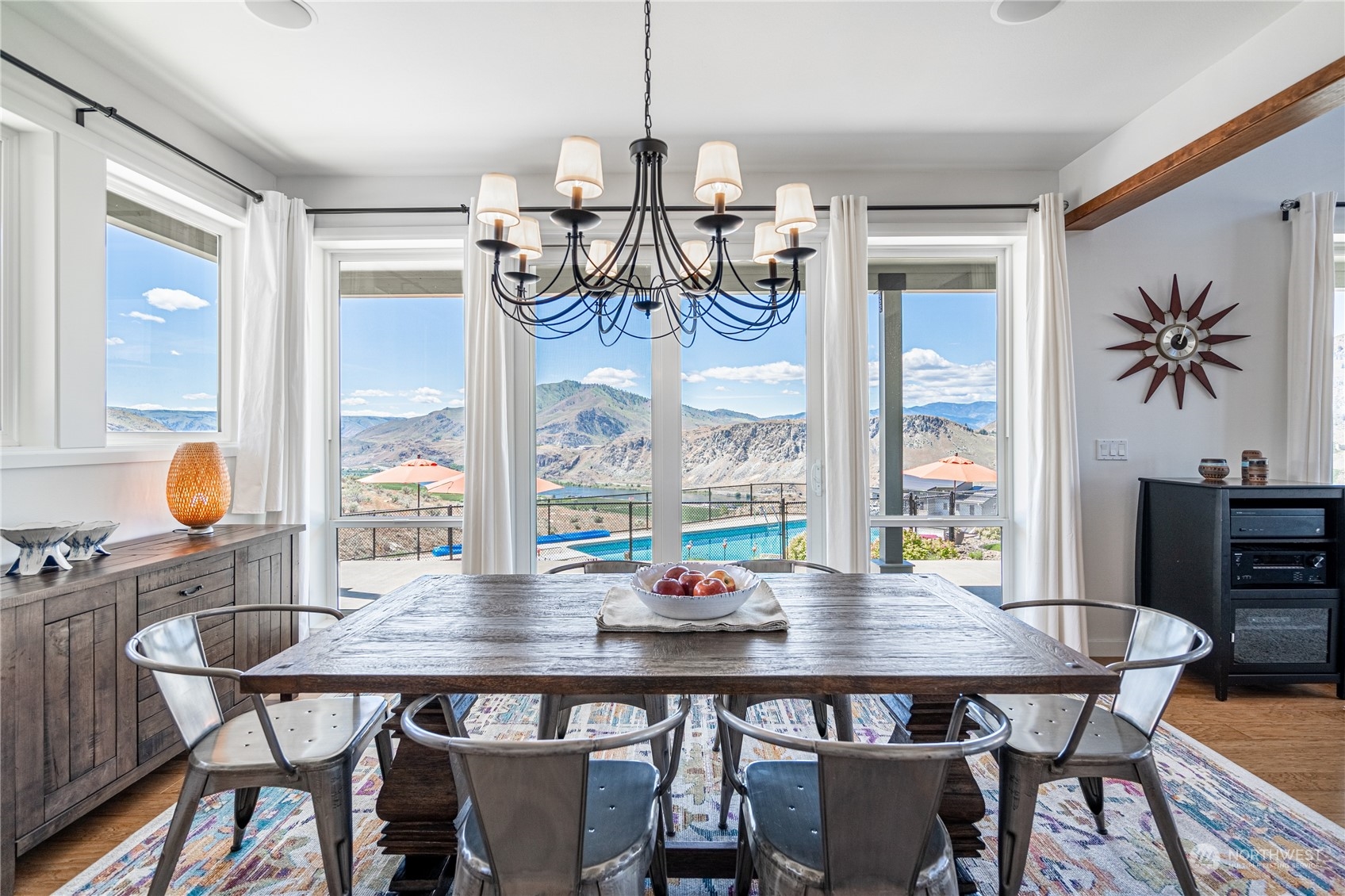200 Ridge Road Orondo, WA 98843 - Photo 7 of 40 a dining room with furniture a chandelier and wooden floor