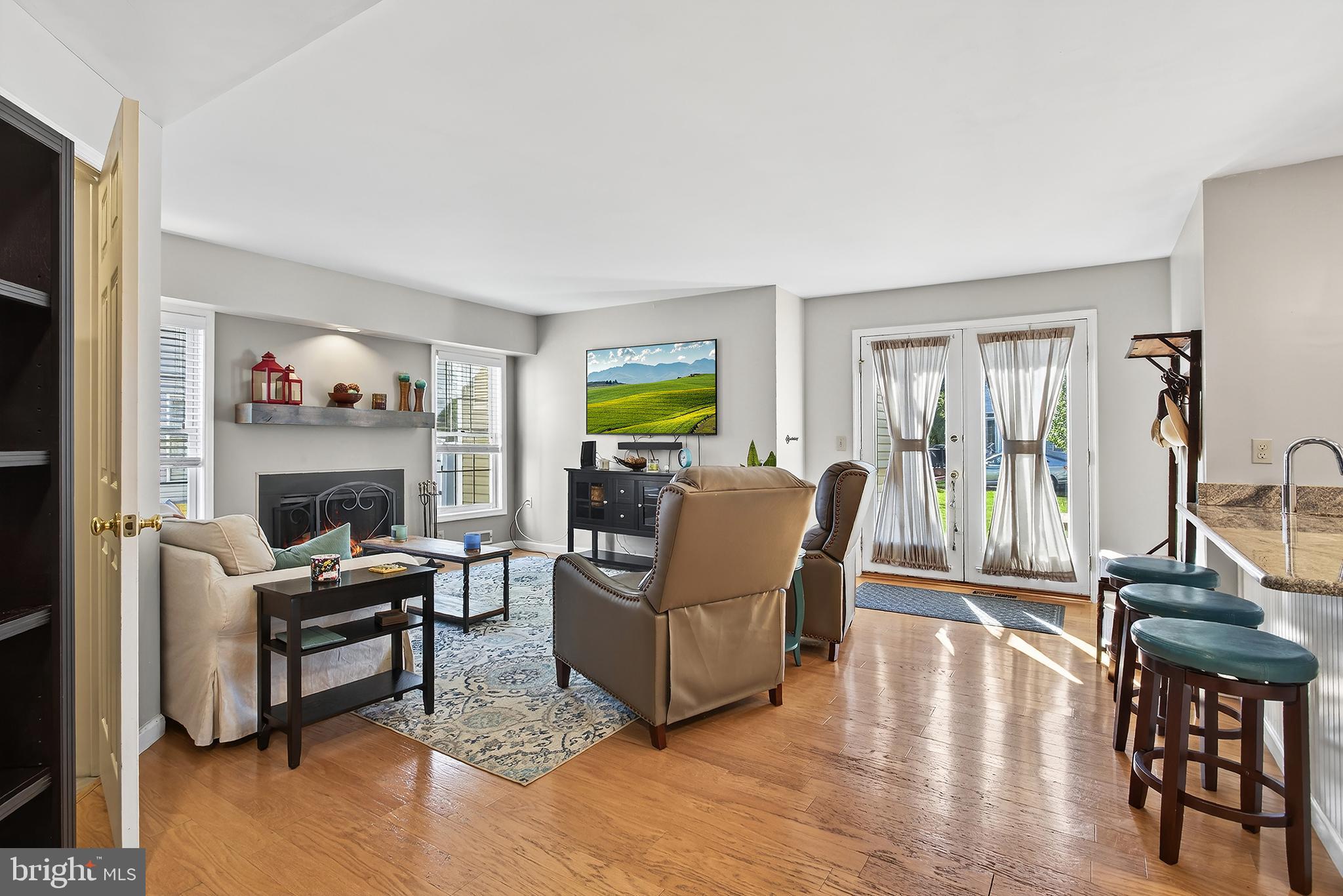17 Elm Street Hopewell, NJ 08525 - Photo 34 of 52 a living room with furniture a fireplace and a flat screen tv