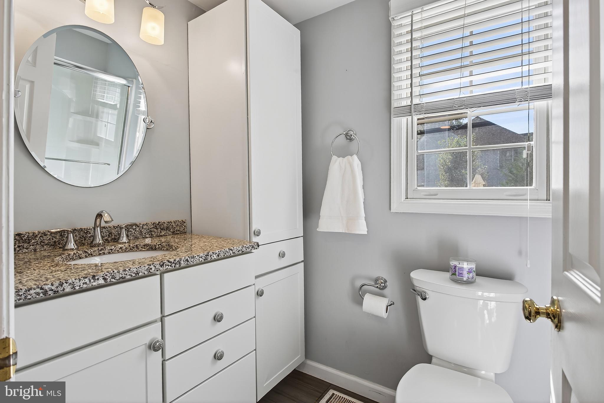 17 Elm Street Hopewell, NJ 08525 - Photo 39 of 52 a bathroom with a granite countertop toilet sink and mirror