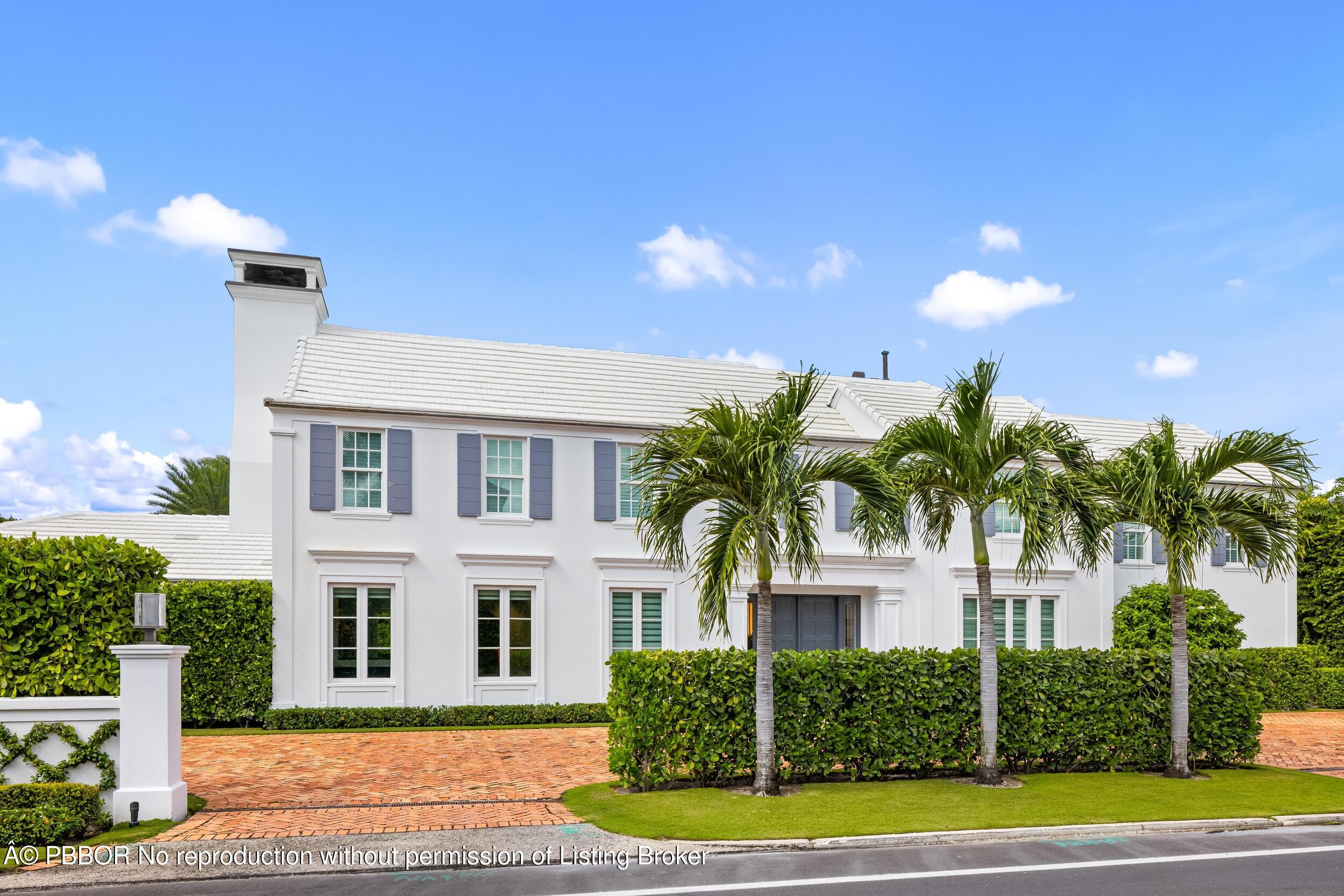 201 Banyan Road Palm Beach, FL 33480 - Photo 2 of 42 a front view of a house with a yard and garage