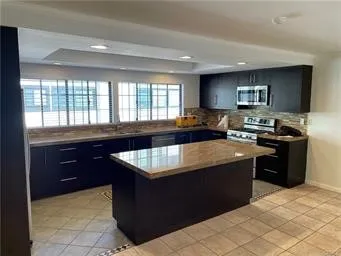 a view of kitchen with refrigerator and window