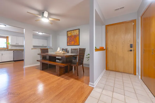 a kitchen with stainless steel appliances kitchen island granite countertop a refrigerator and a stove top oven