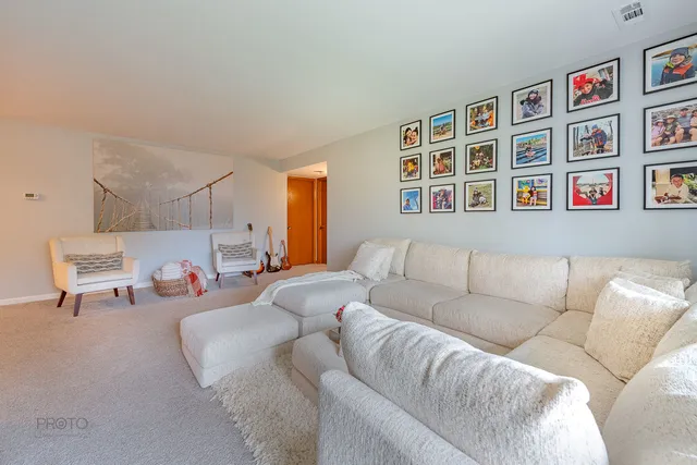 a living room with furniture and baby bed