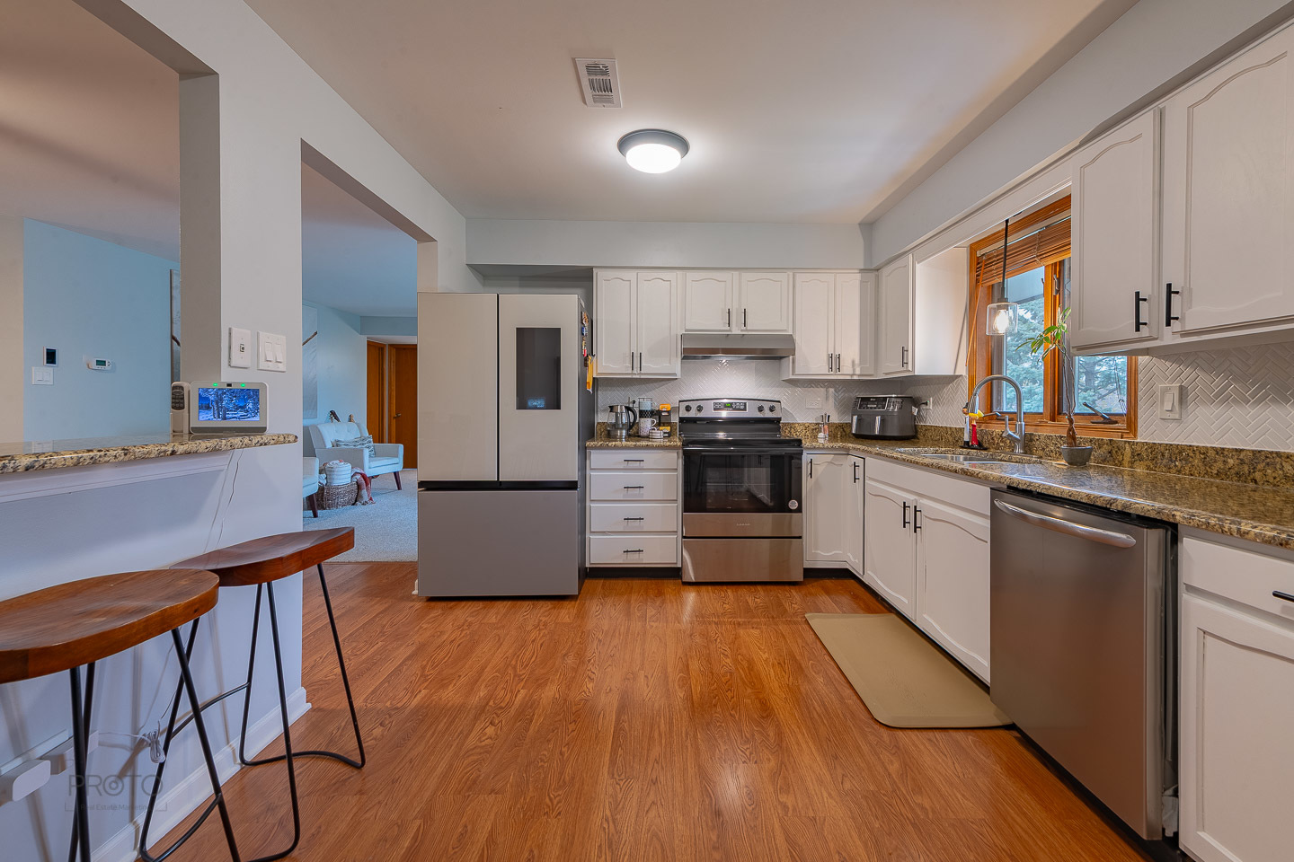 11015 South 84th Avenue, Unit 3C Palos Hills, IL 60465 - Photo 8 of 30 a kitchen with stainless steel appliances a microwave a stove a sink dishwasher a refrigerator and white cabinets with wooden floor