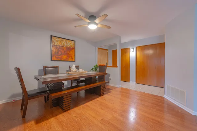 a view of a livingroom with furniture and chandelier fan
