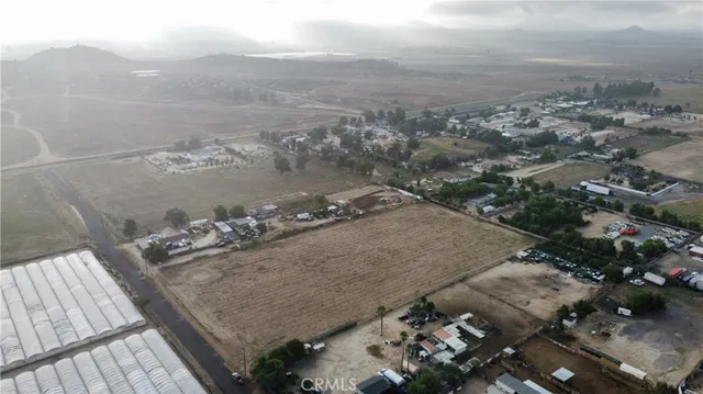 an aerial view of a house with yard
