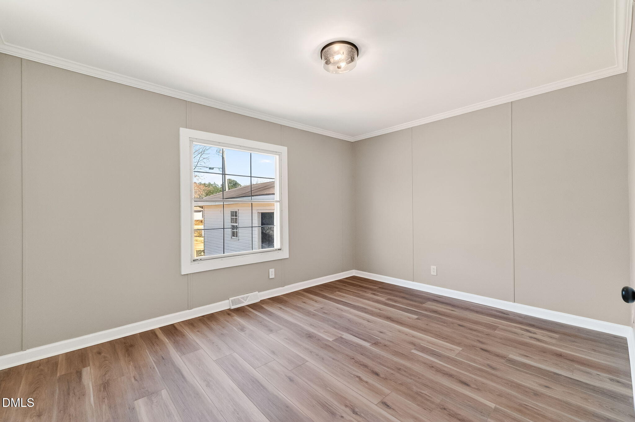 10015 Smith Road Middlesex, NC 27557 - Photo 34 of 48 a view of an empty room with wooden floor and a window