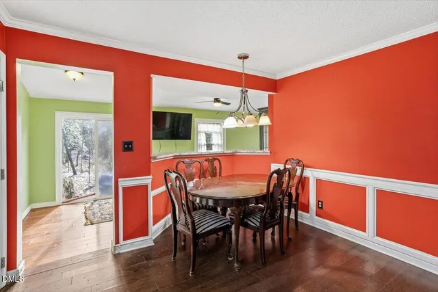 a view of a dining room with furniture and a chandelier