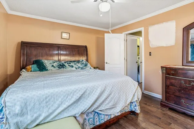 a bedroom with a bed and a mirror