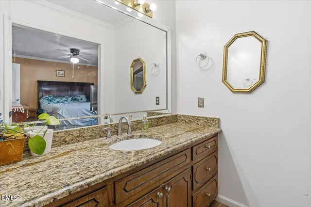 a bathroom with a granite countertop sink a mirror and a