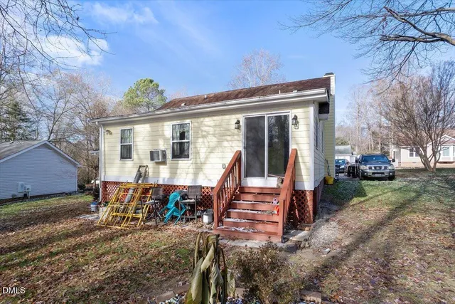 a view of a house with backyard porch and sitting area