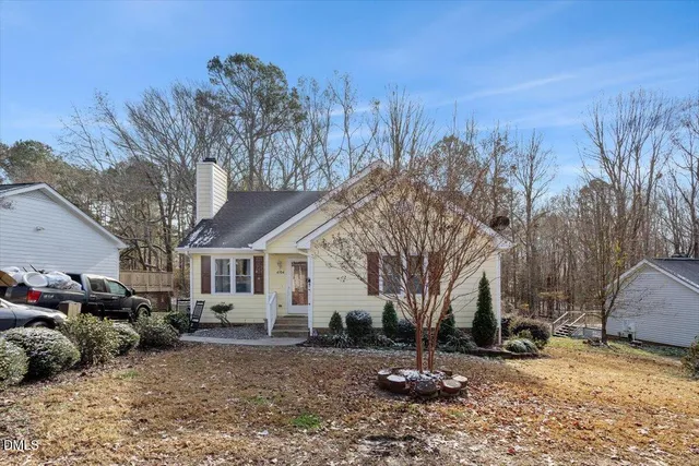 a view of a house with a yard covered in snow