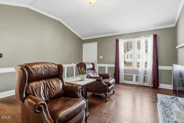 a bed room with furniture and a flat screen tv