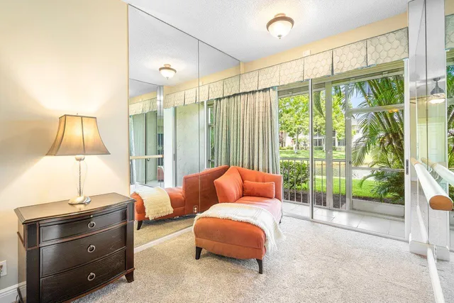 a bedroom with a bed and large window