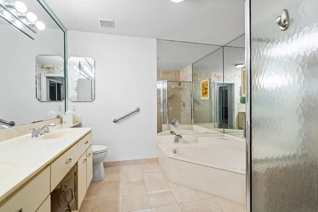 a bathroom with a double vanity sink mirror and shower