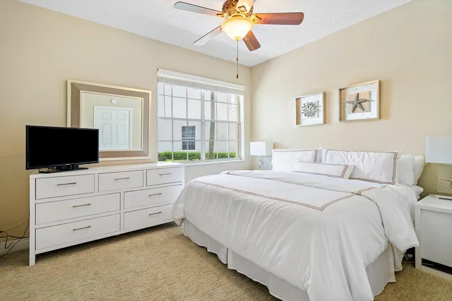 a spacious bedroom with a large bed and a flat screen tv
