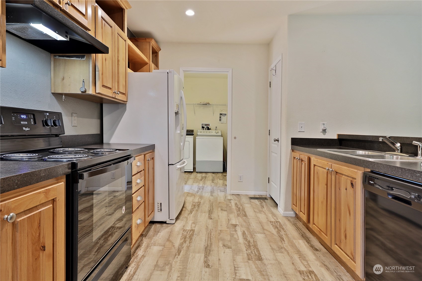 2811 East Andreason Road Langley, WA 98260 - Photo 20 of 38 a kitchen with stainless steel appliances granite countertop a stove and a sink