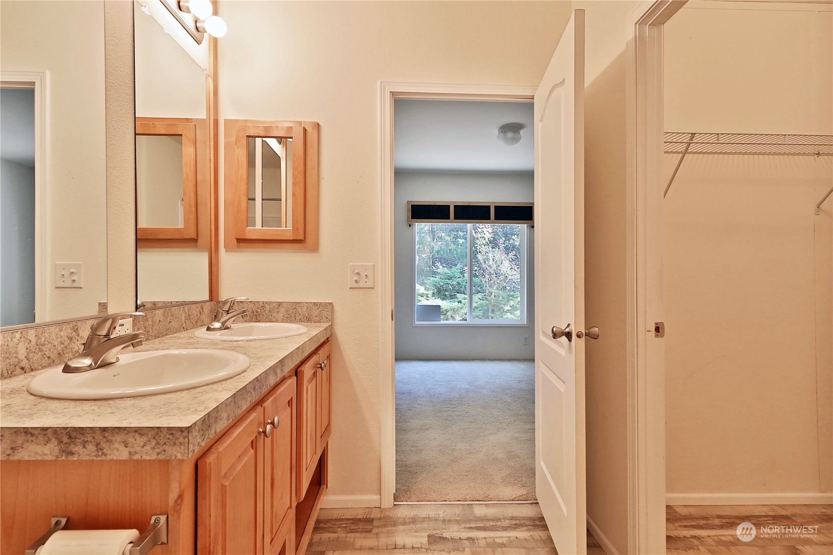 2811 East Andreason Road Langley, WA 98260 - Photo 23 of 38 a en suite bathroom with a granite countertop sink and a mirror