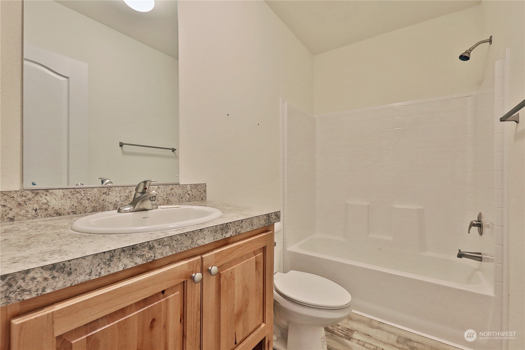 2811 East Andreason Road Langley, WA 98260 - Photo 28 of 38 a bathroom with a granite countertop sink a toilet and bathtub