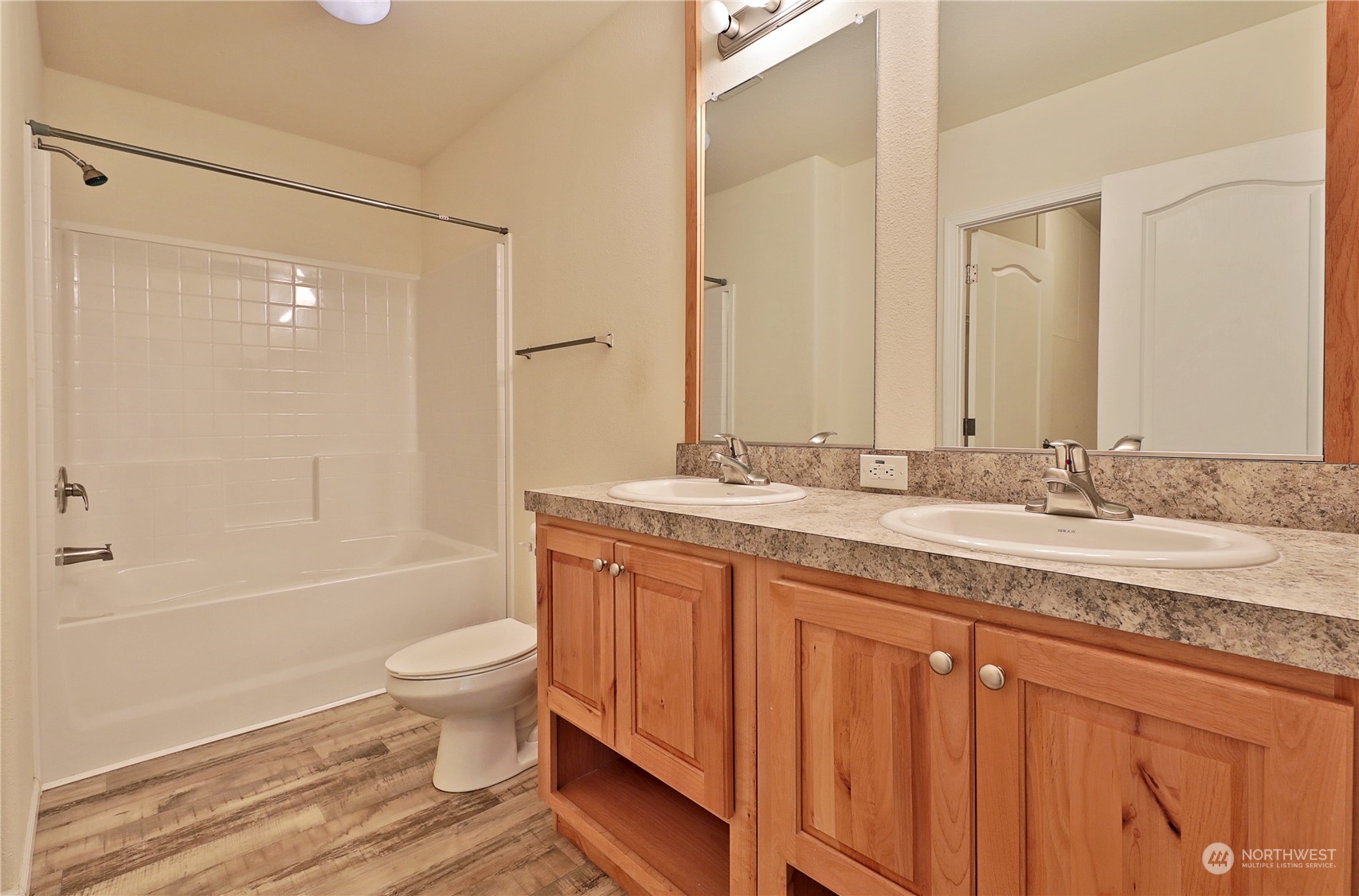 2811 East Andreason Road Langley, WA 98260 - Photo 31 of 38 a bathroom with a granite countertop sink toilet mirror and bathtub