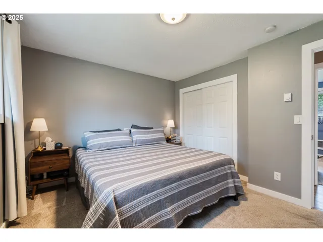 a bedroom with a bed and a lamp