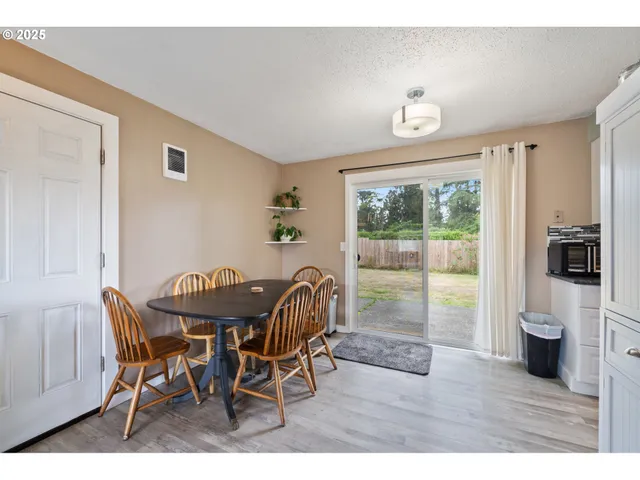 a view of a dining room with furniture and a window